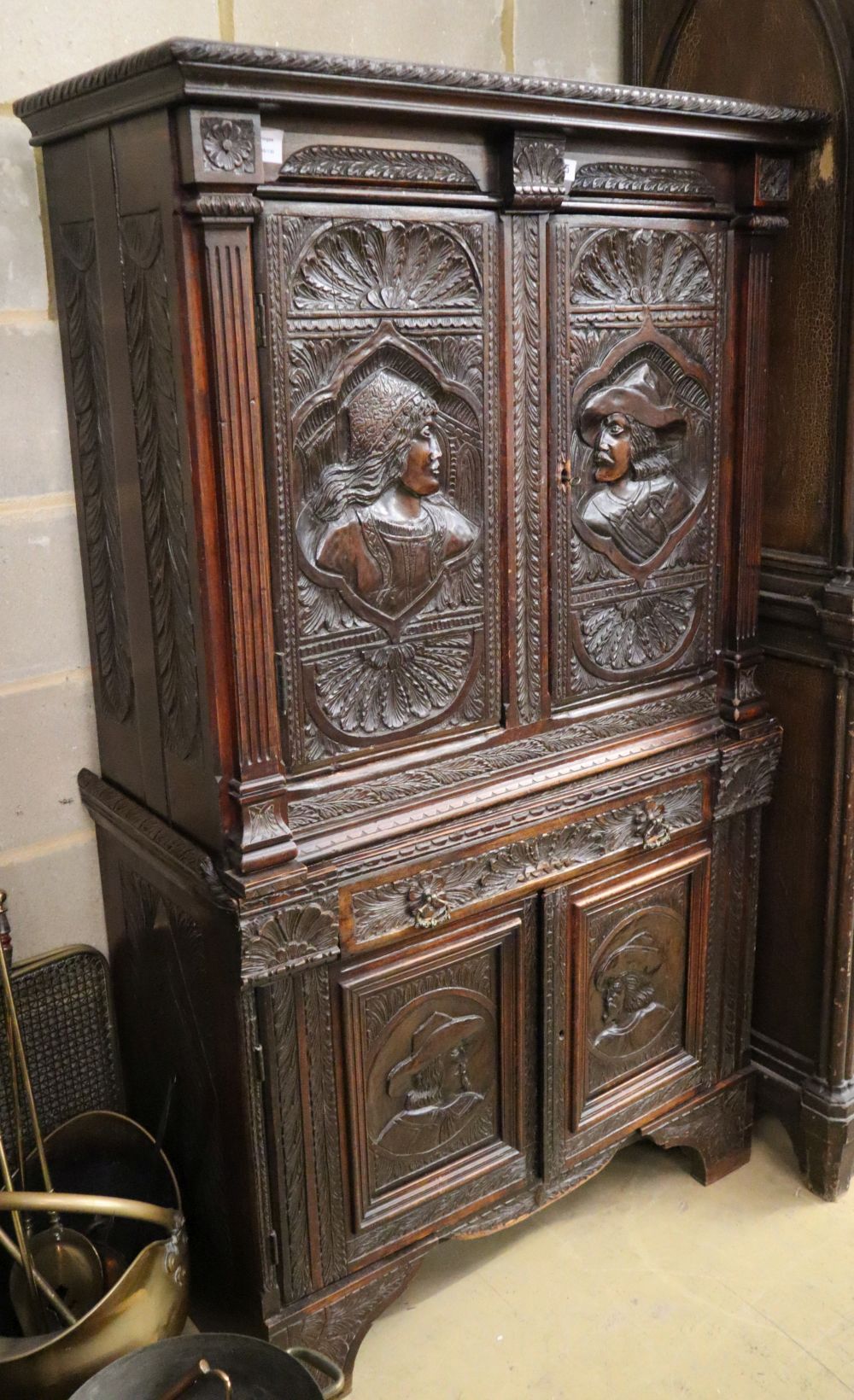 A late 19th century Flemish carved and varnished oak four door cupboard, fitted one drawer, W.94cm, H.160cm